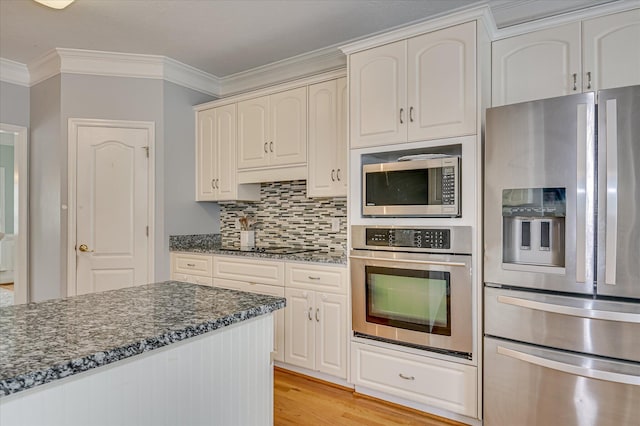 210 Oleander Trl, Evans, GA 30809 - kitchen with appliances with stainless steel finishes, ornamental molding, dark stone countertops, light wood finished floors, and decorative backsplash