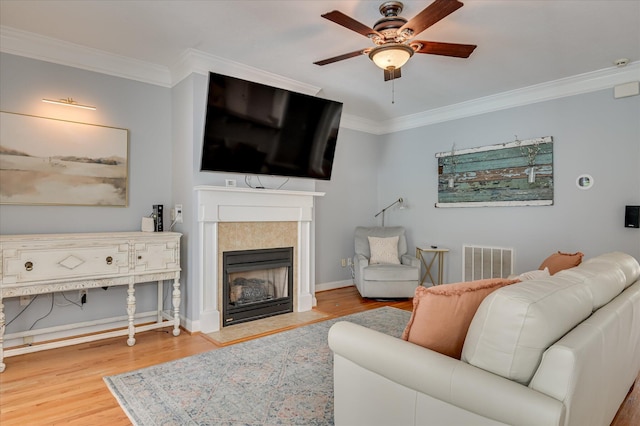 210 Oleander Trl, Evans, GA 30809 - living room with wood finished floors, ceiling fan, ornamental molding, and a glass covered fireplace