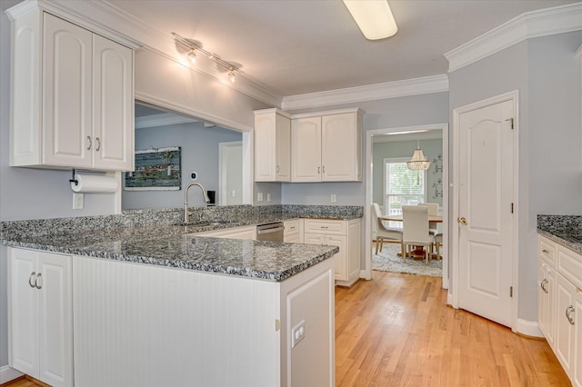 210 Oleander Trl, Evans, GA 30809 - kitchen with dishwasher, light wood-style floors, white cabinets, a peninsula, and dark stone counters