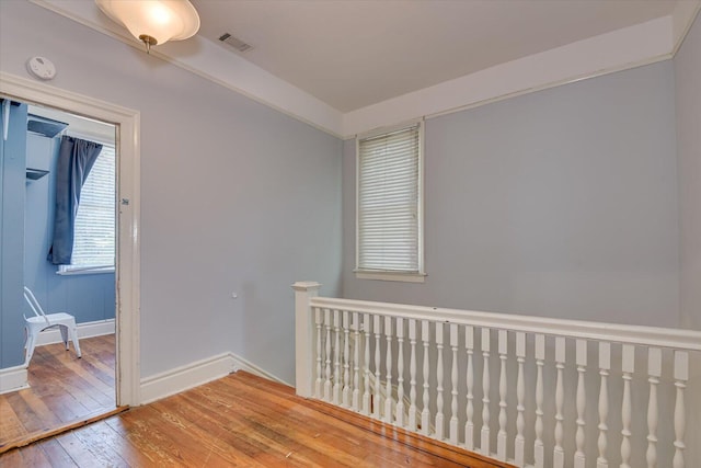 empty room with hardwood / wood-style flooring