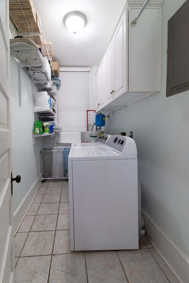 clothes washing area featuring cabinets, independent washer and dryer, and electric panel