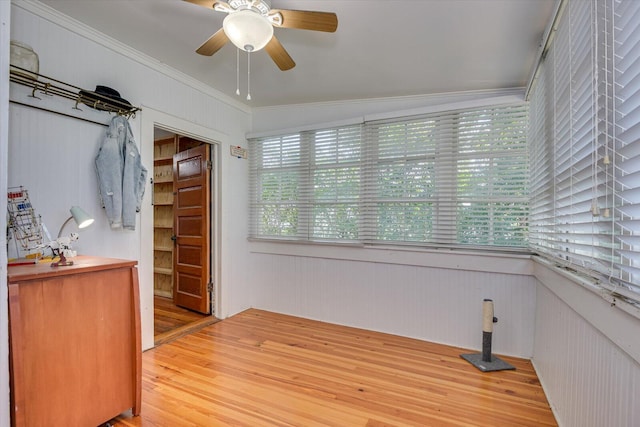 interior space featuring ceiling fan, crown molding, light hardwood / wood-style floors, and vaulted ceiling