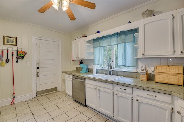 kitchen featuring ceiling fan, sink, stainless steel dishwasher, white cabinets, and ornamental molding