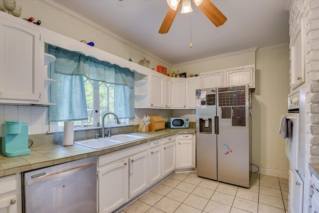 kitchen featuring white cabinetry, sink, and appliances with stainless steel finishes