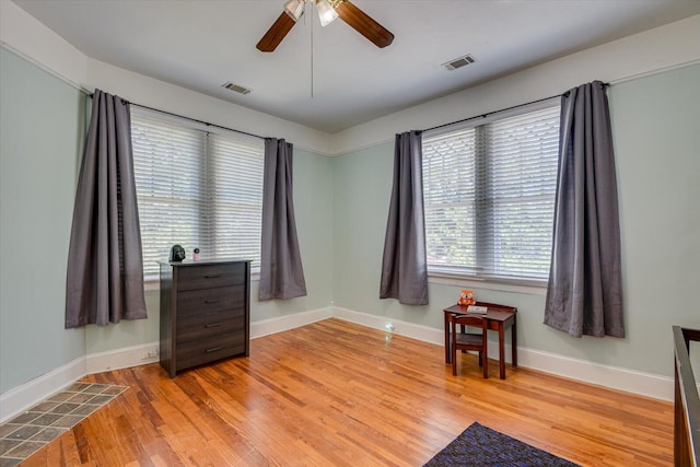 living area featuring ceiling fan and light wood-type flooring