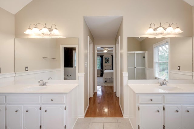 225 Old Mill Rd, Martinez, GA 30907 - ensuite bathroom with two vanities, a stall shower, ceiling fan, tile patterned floors, and a wainscoted wall