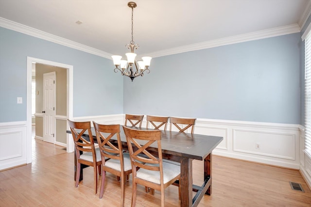 225 Old Mill Rd, Martinez, GA 30907 - dining room with crown molding, a wainscoted wall, a chandelier, light wood-type flooring, and a decorative wall