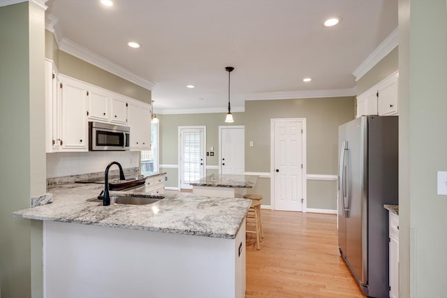 225 Old Mill Rd, Martinez, GA 30907 - kitchen featuring stainless steel appliances, a peninsula, white cabinets, recessed lighting, and light wood finished floors