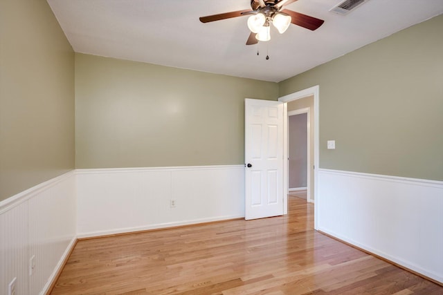 225 Old Mill Rd, Martinez, GA 30907 - spare room featuring wainscoting, a ceiling fan, and light wood-style flooring