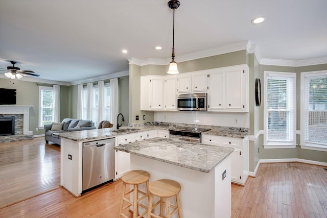 225 Old Mill Rd, Martinez, GA 30907 - kitchen with appliances with stainless steel finishes, a peninsula, light wood-style flooring, ceiling fan, and crown molding