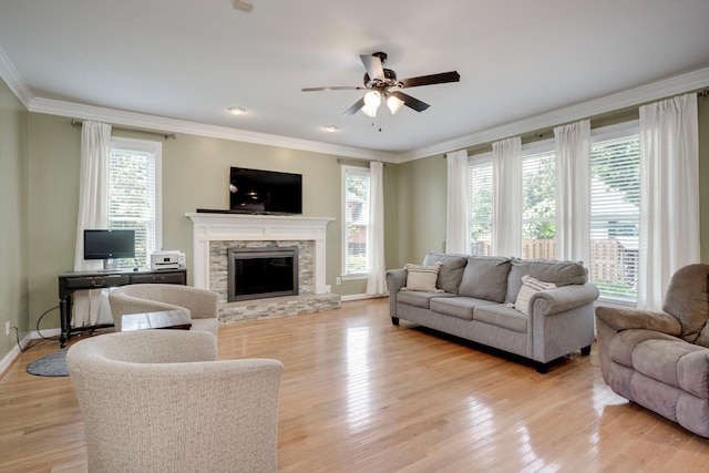 225 Old Mill Rd, Martinez, GA 30907 - living area featuring healthy amount of natural light, ceiling fan, a stone fireplace, ornamental molding, and light wood-style flooring