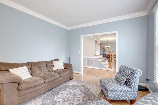 225 Old Mill Rd, Martinez, GA 30907 - living area featuring light wood finished floors, crown molding, a chandelier, and stairway