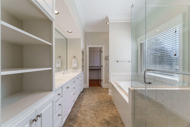 bathroom featuring double vanity, ornamental molding, a garden tub, a shower stall, and a sink