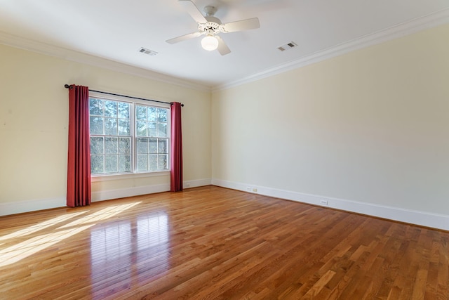 spare room featuring light wood-style flooring, visible vents, and ornamental molding