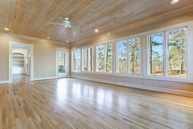 interior space featuring arched walkways, recessed lighting, light wood-style flooring, ornamental molding, and wood ceiling