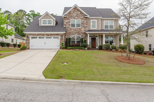 322 Pump House Rd, Evans, GA 30809 - craftsman house featuring driveway, a front yard, stone siding, and a garage