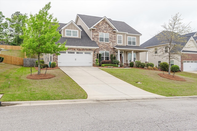322 Pump House Rd, Evans, GA 30809 - craftsman-style home with concrete driveway, stone siding, a front lawn, a garage, and fence
