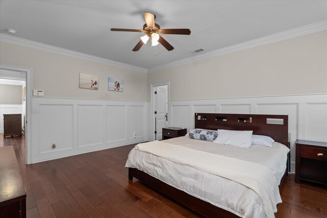 322 Pump House Rd, Evans, GA 30809 - bedroom featuring crown molding, a decorative wall, dark wood finished floors, and a wainscoted wall
