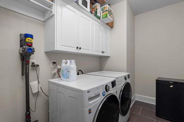 322 Pump House Rd, Evans, GA 30809 - laundry area with dark tile patterned flooring, separate washer and dryer, baseboards, and cabinet space