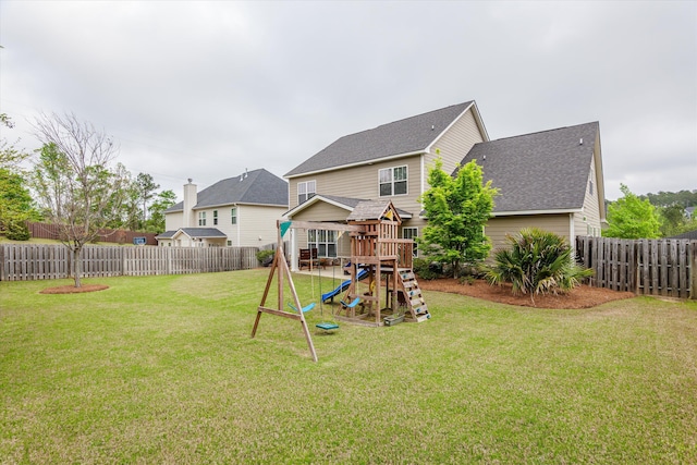 322 Pump House Rd, Evans, GA 30809 - back of property with a fenced backyard, a playground, a shingled roof, and a lawn