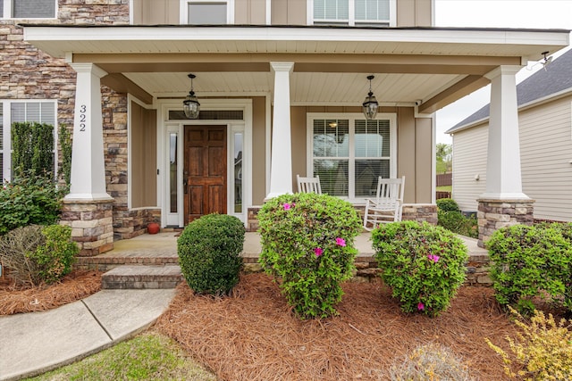 322 Pump House Rd, Evans, GA 30809 - doorway to property featuring board and batten siding, covered porch, and stone siding