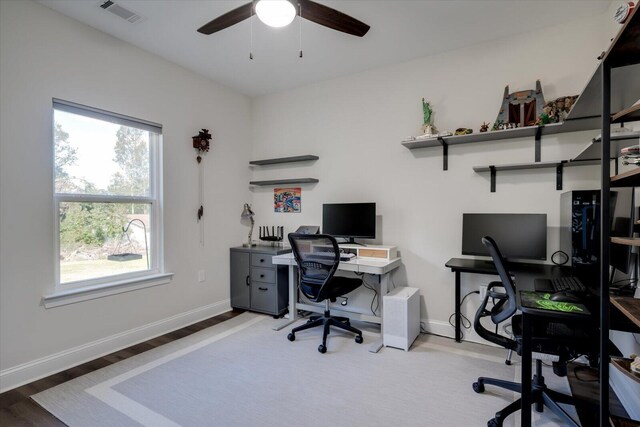 office with ceiling fan and light hardwood / wood-style flooring