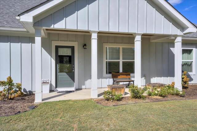 property entrance featuring a porch and a yard