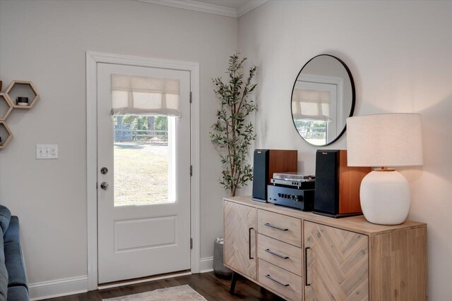 doorway to outside with crown molding and dark wood-type flooring