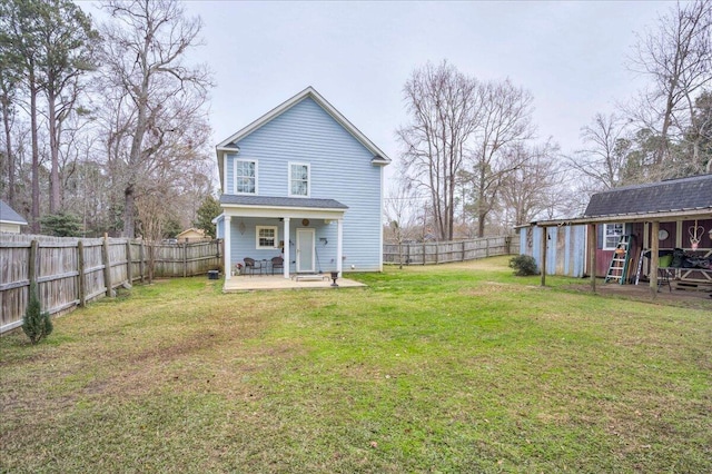 rear view of property featuring a yard and an outdoor structure