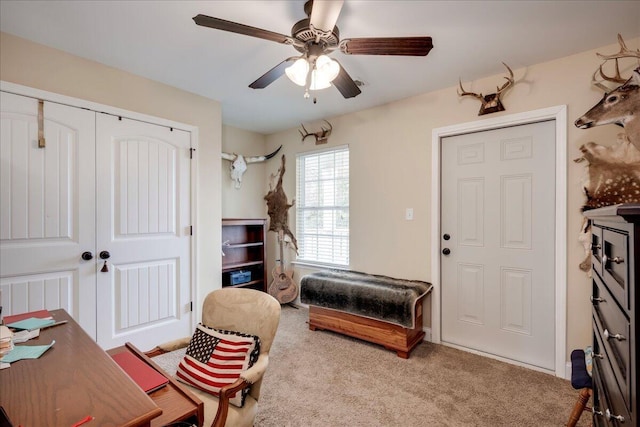 interior space with light carpet and ceiling fan