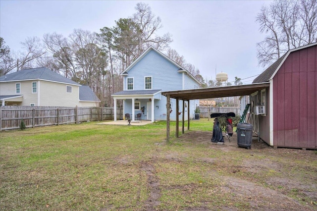 rear view of house with a patio, a shed, cooling unit, and a lawn