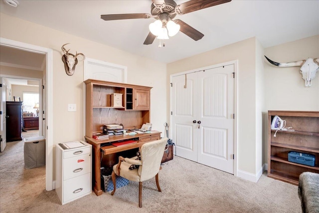 office space featuring ceiling fan and light carpet