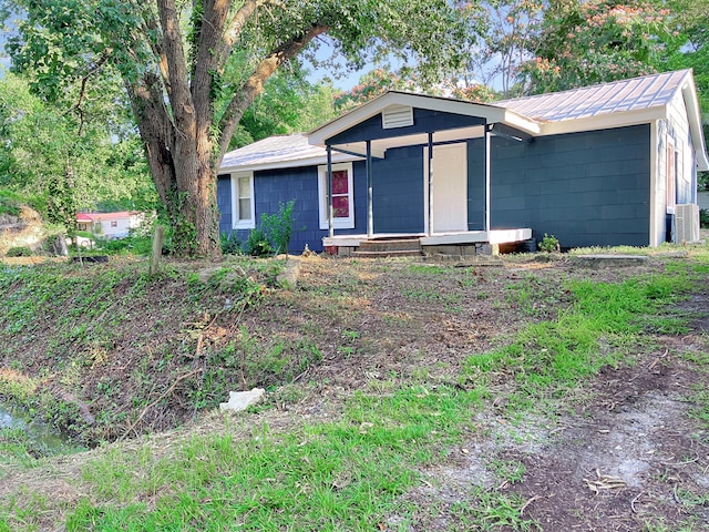 599 Twin Oaks Rd, Thomson, GA 30824 - ranch-style house with concrete block siding and a metal roof