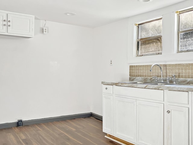 599 Twin Oaks Rd, Thomson, GA 30824 - kitchen with decorative backsplash, white cabinetry, dark wood-type flooring, and light countertops