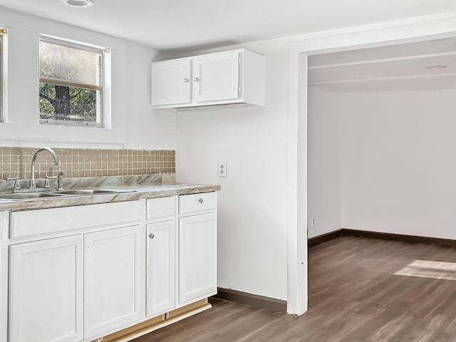 599 Twin Oaks Rd, Thomson, GA 30824 - kitchen featuring dark wood-style floors, light countertops, backsplash, and white cabinetry
