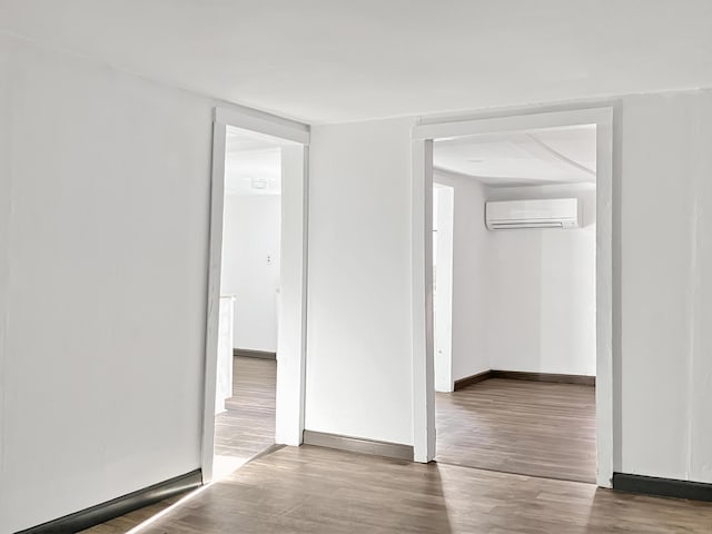 599 Twin Oaks Rd, Thomson, GA 30824 - spare room with a wall unit AC and wood finished floors