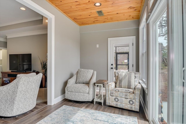 sitting room with baseboards, wood ceiling, wood finished floors, crown molding, and recessed lighting