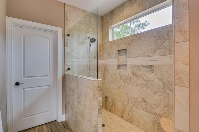 bathroom featuring a walk in shower and wood finished floors