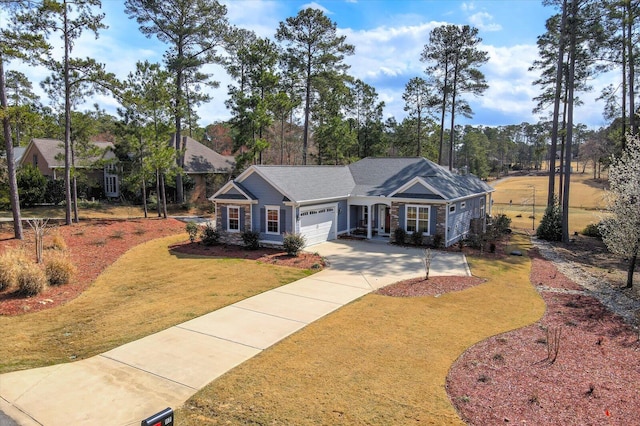 view of front of house with driveway, a front lawn, and an attached garage