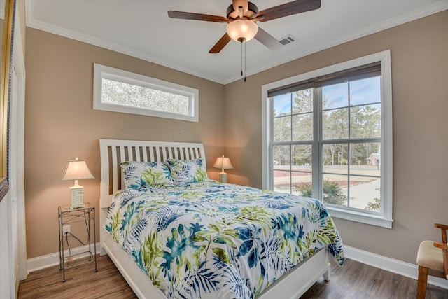 bedroom featuring multiple windows, visible vents, and ornamental molding