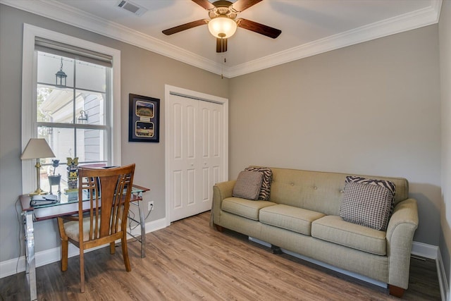 office area featuring ornamental molding, visible vents, baseboards, and wood finished floors