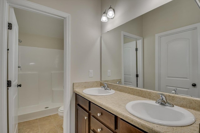 bathroom featuring vanity, toilet, and walk in shower