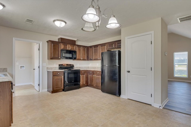 kitchen with pendant lighting, vaulted ceiling, a notable chandelier, and black appliances