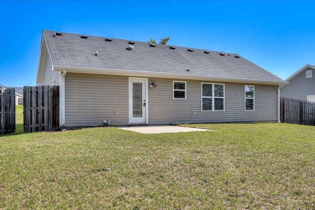 rear view of house featuring a patio area and a yard