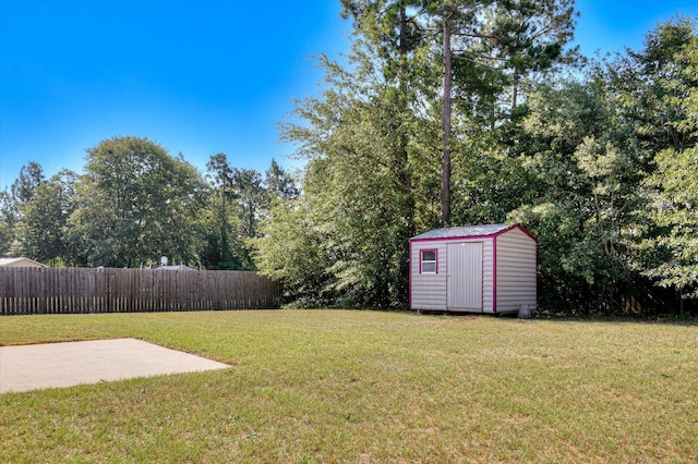 view of yard with a storage unit and a patio