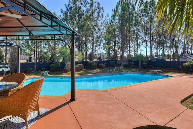 view of swimming pool with a diving board and a patio