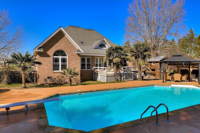 view of pool with a gazebo and a diving board