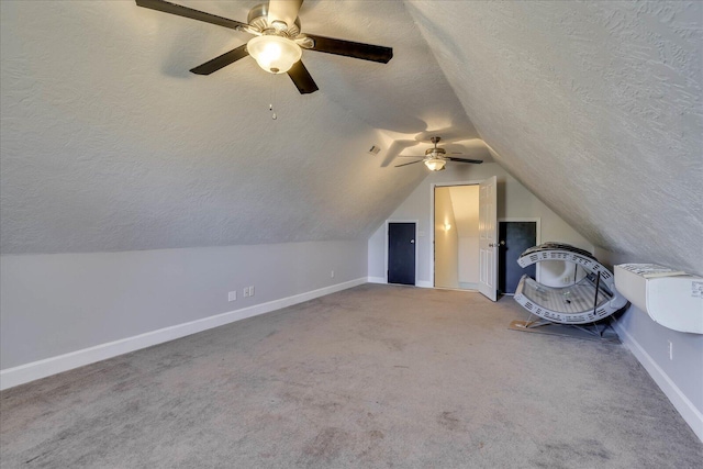 bonus room with vaulted ceiling, carpet floors, and a textured ceiling