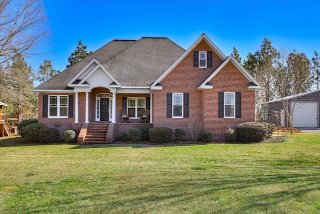 view of front of property featuring an outbuilding, a garage, and a front yard