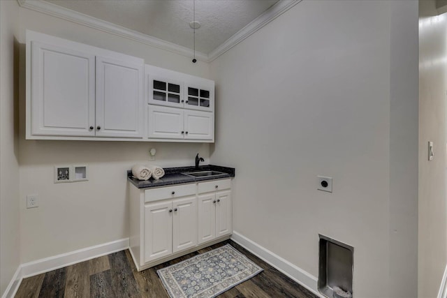 clothes washing area with sink, crown molding, dark wood-type flooring, electric dryer hookup, and hookup for a washing machine